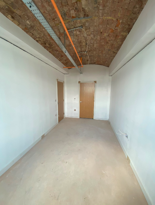 Level 6 bedroom with exposed brickwork ceiling at Brunswick Mill