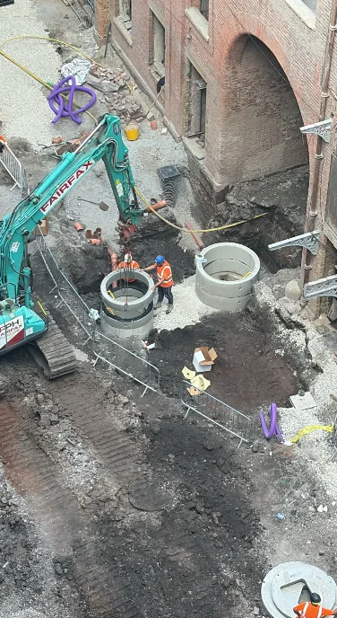 Main drainage being installed in the courtyard beside the original arched Mill entrance