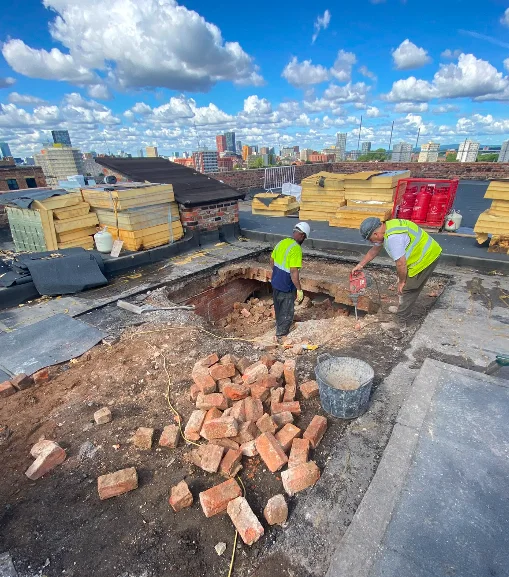 Contractors breaking through the main roof at Brunswick Mill for a new lift core