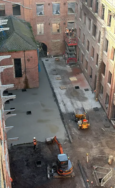 Courtyard floor concreting at Brunswick Mill, ready for the original cobblestones to be re-laid