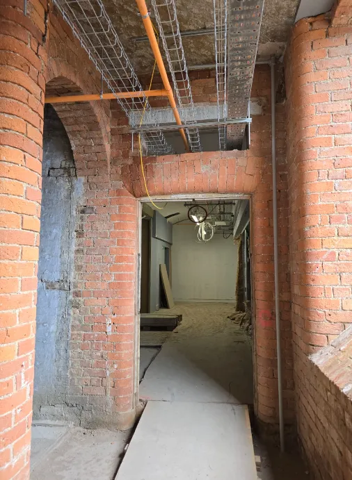 Lift lobby and staircase corridor cable tray installation at Brunswick Mill, ready for electrical wiring