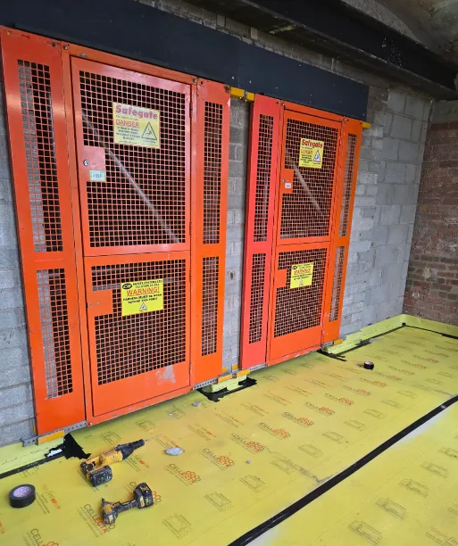 Safety gates installed on the lift shafts at Brunswick Mill, ready for lift installation