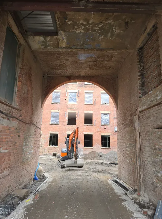 Original Mill main entrance archway, becoming an open walkway from Bradford Road into the commercial area and garden