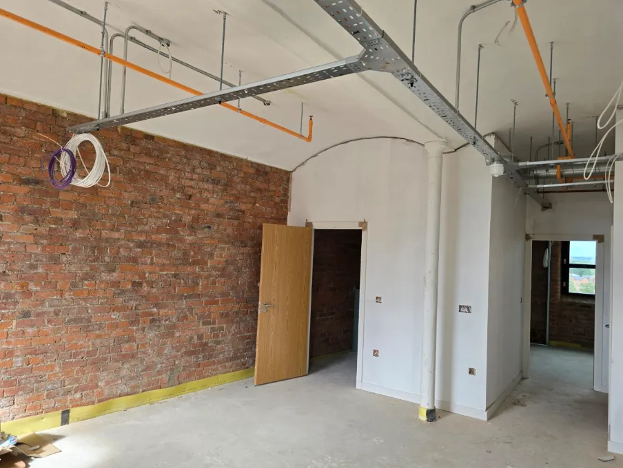 Apartment room preparation at Brunswick Mill, ready for curved ceiling trims, skirting and flooring